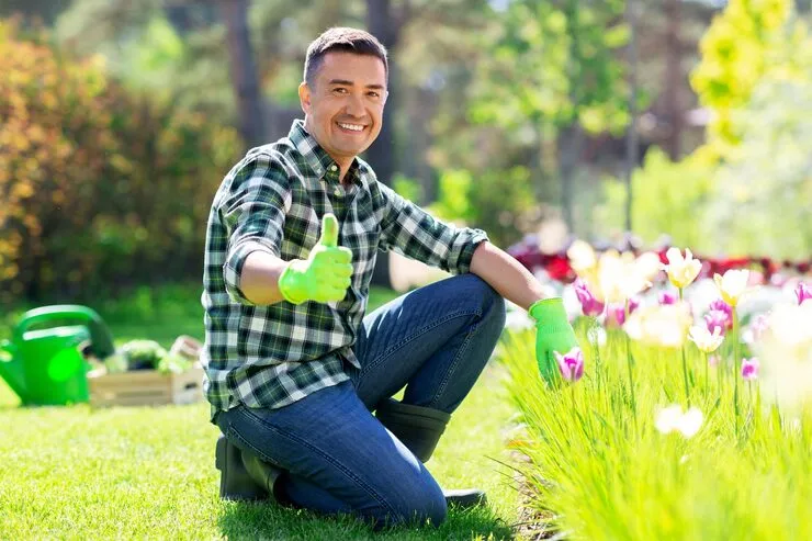 Gardener providing maintenance in a lush garden